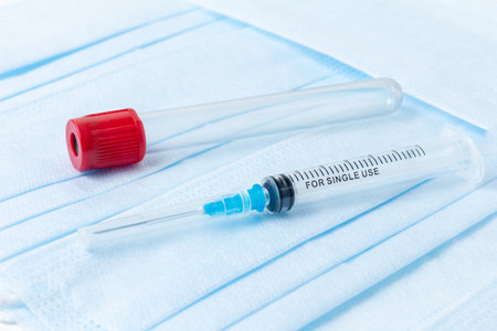 Syringe and empty test tube for the collection and analysis of venous blood on a medical backgroundの写真素材