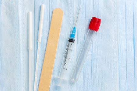 Rapid laboratory analysis of nasal and oral smears in the hospital laboratory and medical instruments for vaccination: syringe, test tube and spatula. Victory over the coronavirusの写真素材