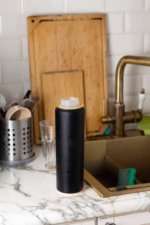 Old water filter cartridge in the kitchen on the background of sinks and dishesの写真素材