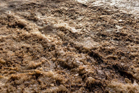 Dirty snow with sand and salt. Deicing winter roadsの写真素材