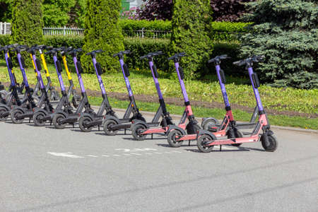 Saint Petersburg, Russia - May 30, 2021: Electric scooters in the parking lot of the rental station. Modern mobile transport for moving around the cityのeditorial素材