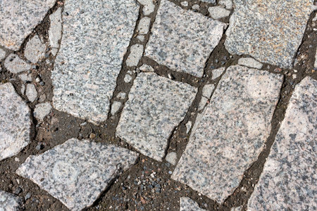 Old gray marble paving slabs of different sizesの写真素材