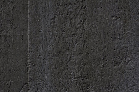 Textured surface of a dark concrete wall of an army buildingの写真素材