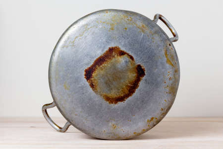 Bottom old aluminum pan with traces of burnt and sootの写真素材