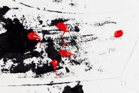 Bright drops of red paint on black chaotic brush strokes and abstract spots on a light background