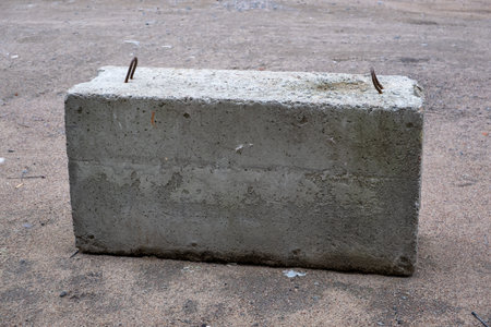 Heavy concrete barrier or cement block on the groundの写真素材