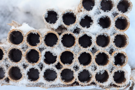 Used packaging for fireworks and pyrotechnics on the snow after the New Year celebrationの写真素材