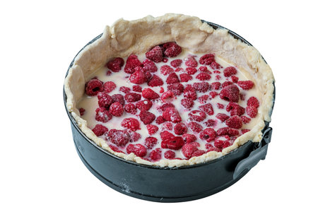 Cooking raspberry pie. Cake in a round baking dish on a white backgroundの写真素材