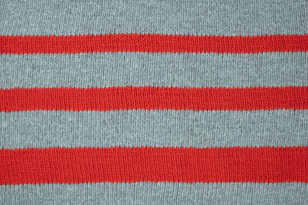 Textured woolen fabric in red and gray stripes - wool knittingの写真素材