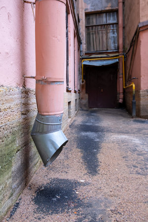 Drainpipe by the front door. old residential building.の写真素材