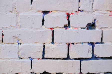 An old brick wall with traces of colorful paintの写真素材