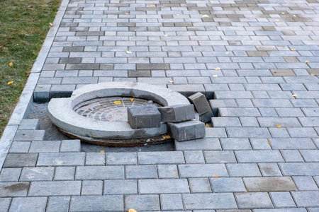 Laying curbs and paving stones around the mouth of the hatch