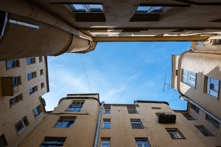 Old city architecture courtyard-well view from below on blue skyの写真素材