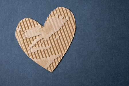 Cardboard hearts on a dark blue festive background. Valentine's day photo with empty space for text. For print, cards and wallpaperの写真素材