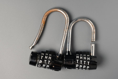 Two unreliable broken padlocks with a codeの写真素材