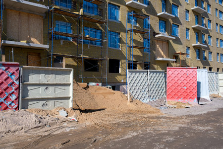The process of construction of a new multi-apartment residential building fenced with a concrete...
