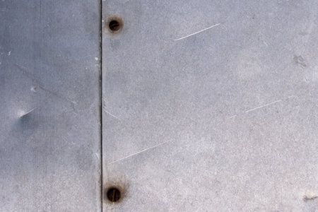 Aluminum sheets with dents and scratches, bolted togetherの写真素材