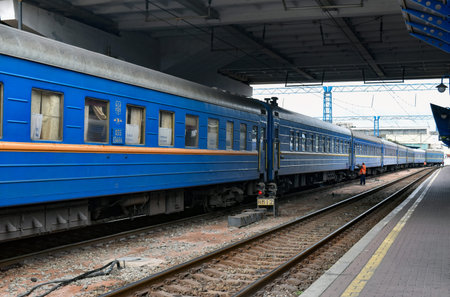 Passenger train on the platform of a railway stationの写真素材