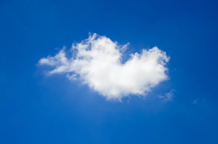 Fluffy cloud of the shape of heart, on blue sky background