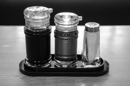 Soy Sauce, Sesame oil and pepper bottles on wooden table.の写真素材