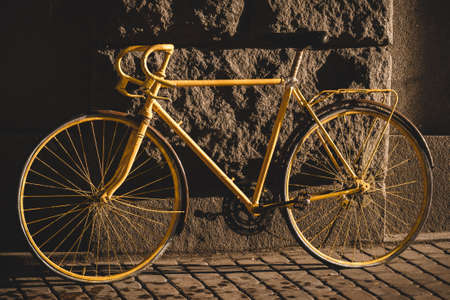 The vintage hybrid bicycle parking against wallの写真素材