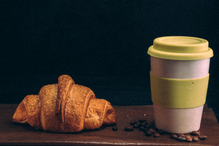 croissant with a mug of coffee. retro style grain effect