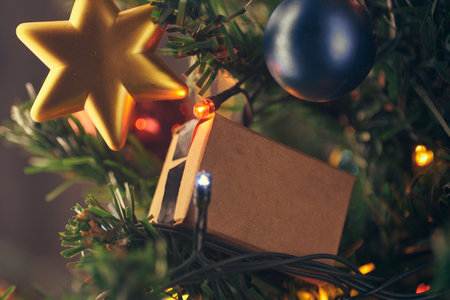 gift box on christmas tree with garlandsの写真素材