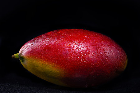 mango isolated on black backgroundの写真素材