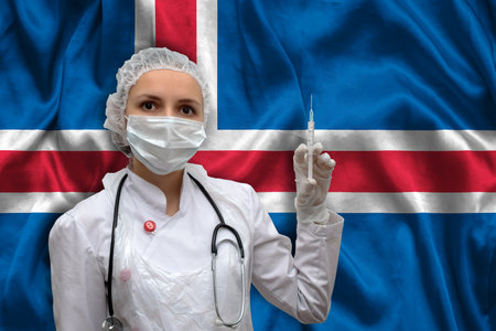 Young woman doctor in medical uniform on the background of the national flag of Slovakia is holding a syringe. The concept of a new vaccine against the disease, flu vaccine vaccinationの写真素材