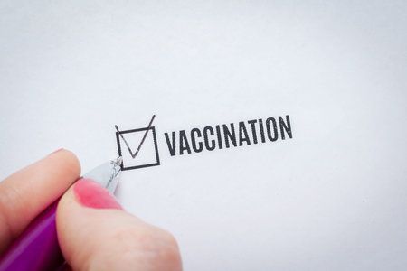 Vaccination is a positive answer in the questionnaire. The hand of a young woman fills the checklist...
