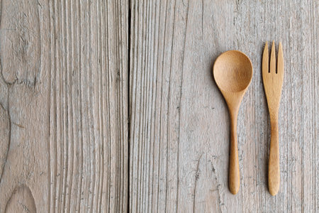 Wooden spoon and fork on tableの写真素材