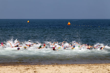 KAGAWA, JAPAN - AUGUST 26:Triathlon Athletes race to the water at the start of the sea swim in the 2012 Triathlon Japanese University Cup, August 26, 2012 in Kagawa, Japan.のeditorial素材