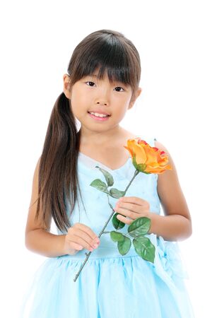 Photo of little asian girl holding rose flowerの写真素材