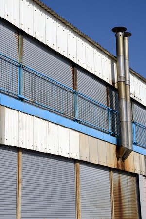 old rusty refinery exterior against blue skyの写真素材