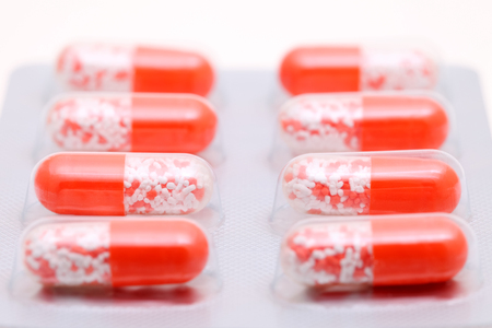 Pills in a blister pack on a white background の写真素材