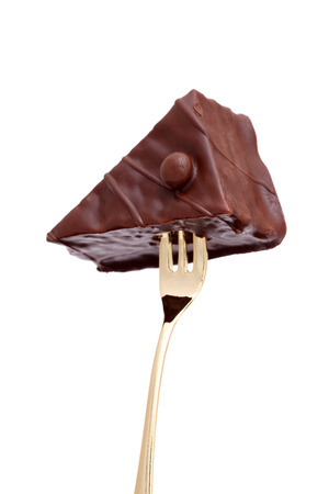 fork sticking in a chocolate cakeの写真素材