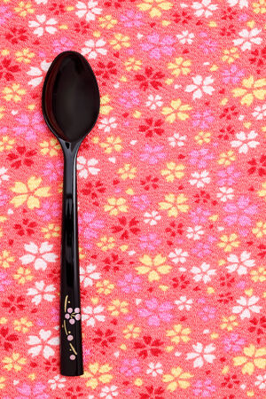 Japanese lacquer spoon on tableclothの写真素材