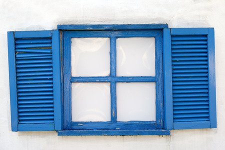 A window closed with weathered wooden shutterのeditorial素材