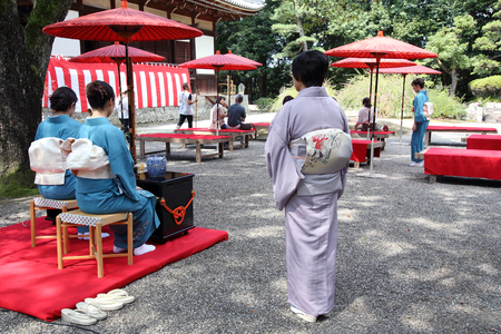 KAGAWA, JAPAN-SEPTEMBER 20, 2015: Japanese woman in traditional kimono prepares the tea ceremony at garden of the Hagiwara Temple on September 20, 2015 in Kagawa Japan.のeditorial素材
