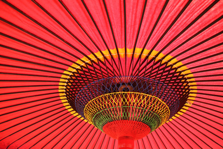 Design underneath the red Japanese umbrellaの写真素材