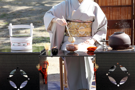 KAGAWA, JAPAN-OCTOBER 25, 2015: Japanese woman in traditional kimono prepares the tea ceremony at garden of the Marugame-castle on October 25, 2015 in Kagawa Japan.のeditorial素材