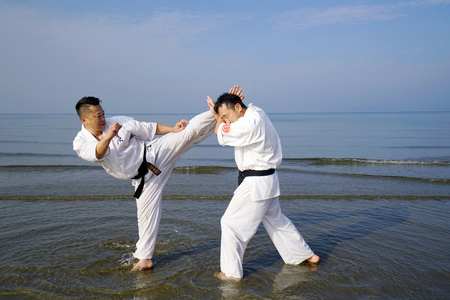 KAGAWA, JAPAN-Jan 3: Japanese karate men training of karate fighting in midwinter of a new year at Ichinomiya Beach, January 3, 2016, Kagawa, Japanのeditorial素材