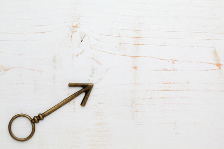 metal arrow on white wood backgroundの写真素材