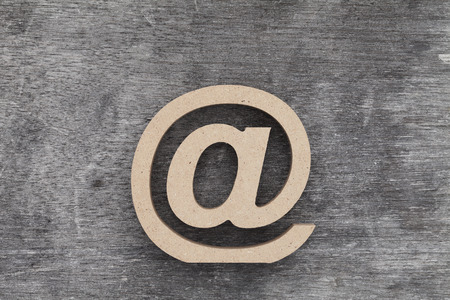 E-mail symbol on grunge wood background (Commercial At Symbol)の写真素材