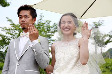 KAAWA, JAPAN-MAY 15, 2016: Beautiful Japanese wedding couple wedding in Zentuji-oakunosato Park. Young wedding couple, beautiful bride with groom portrait.のeditorial素材