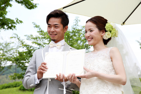 KAGAWA, JAPAN-MAY 15, 2016: Beautiful Japanese wedding couple wedding in Zentuji-Gogakunosato Park. Young wedding couple, beautiful bride with groom portrait.のeditorial素材