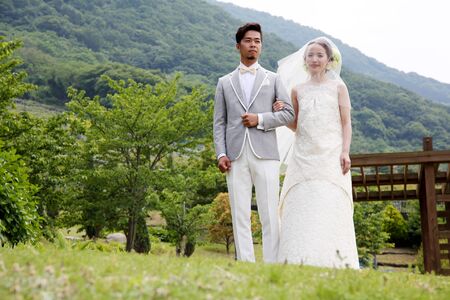 KAGAWA, JAPAN-MAY 15, 2016: Beautiful Japanese wedding couple wedding in Zentuji-Gogakunosato Park. Young wedding couple, beautiful bride with groom portrait.のeditorial素材