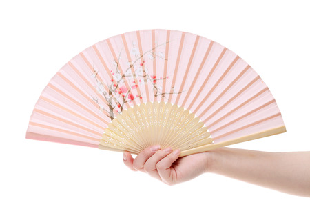 Hand holding folding fan isolated on a white backgroundの写真素材