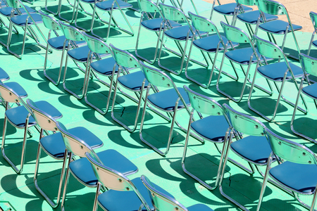 rows of folding chairs at eventの写真素材