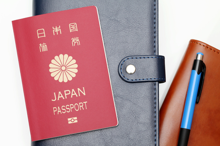 japan passport and leather notebook isolated on white backgroundの写真素材